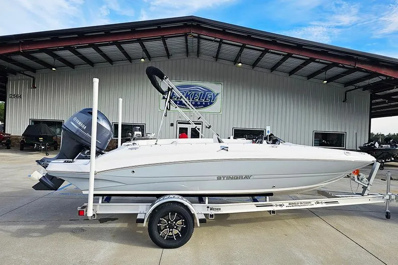 The Image of 2026 Stingray 182 SC boat on trailer outside dealership, featuring Yamaha engine. - 1