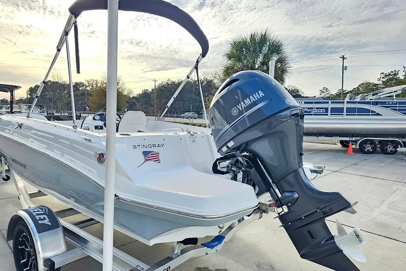 Slide: The Image of 2026 Stingray 182 SC boat with Yamaha outboard motor on trailer, parked outdoors. - 10