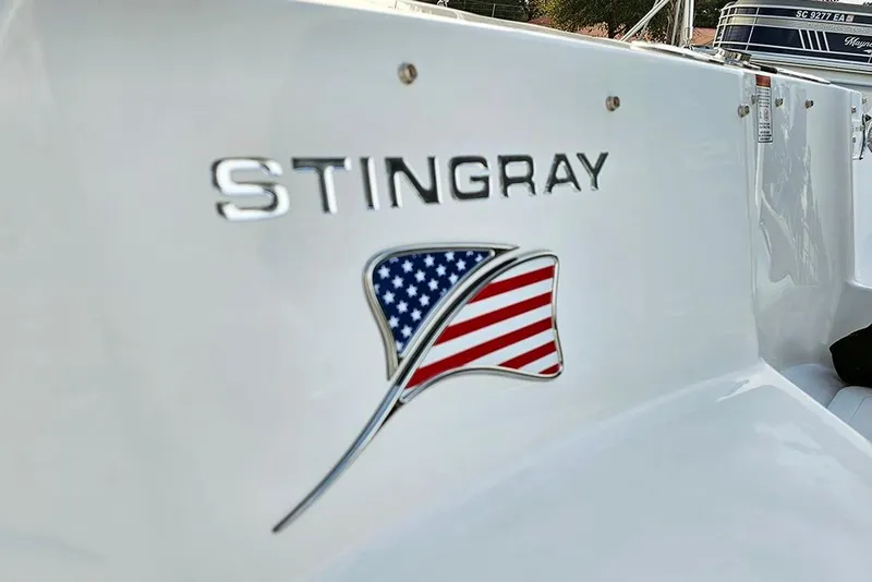 Slide: The Image of 2026 Stingray 182 SC boat with American flag emblem on white surface. - 11