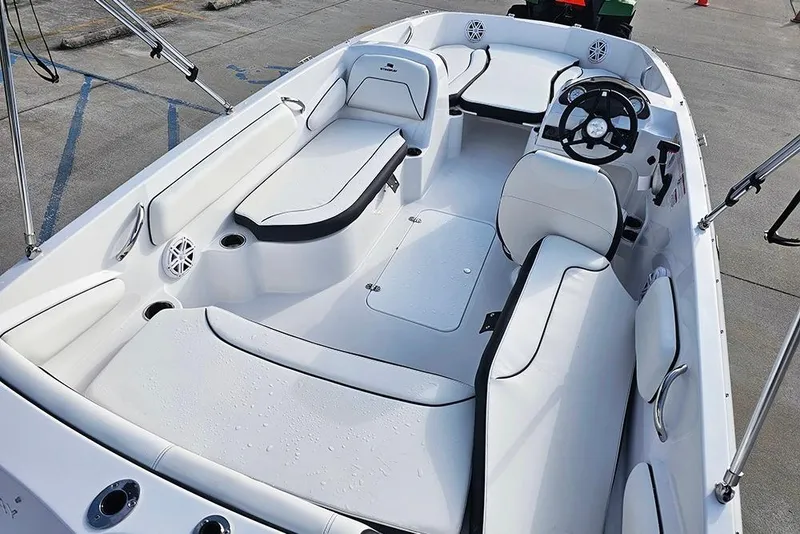 Slide: The Image of 2026 Stingray 182 SC boat interior with white seating and steering wheel. - 12