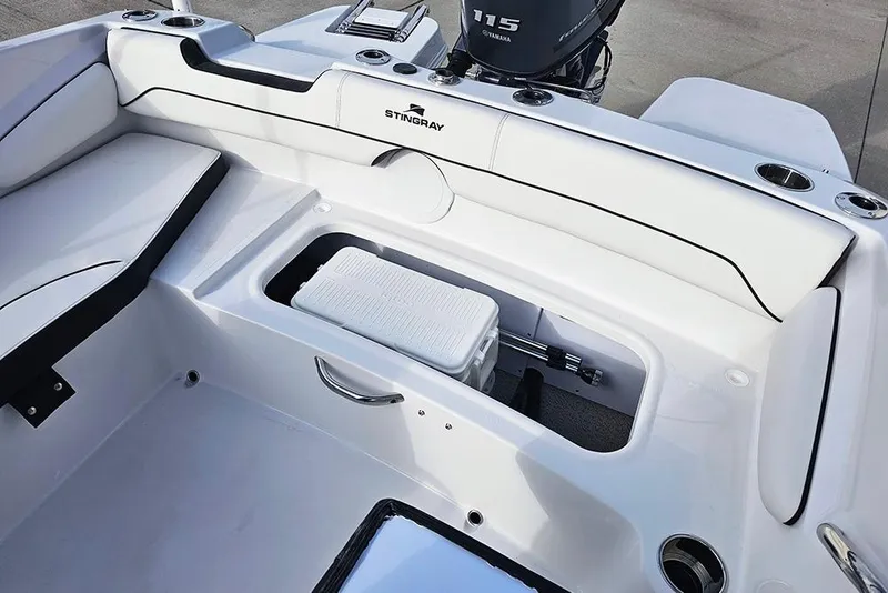 Slide: The Image of 2026 Stingray 182 SC boat interior with seating and storage compartment. - 14