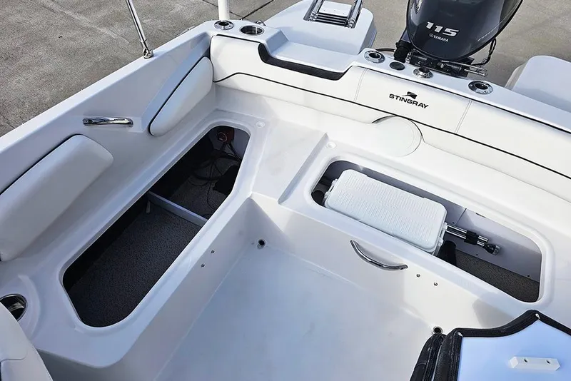 Slide: The Image of 2026 Stingray 182 SC boat interior with storage compartments and Yamaha 115 engine. - 15