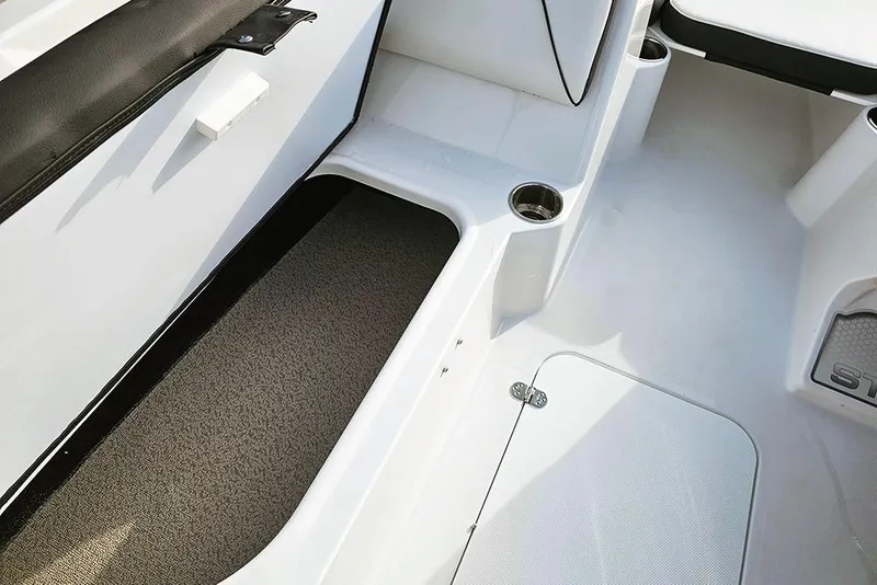 Slide: The Image of Interior of 2026 Stingray 182 SC boat, featuring seating and cup holders. - 17