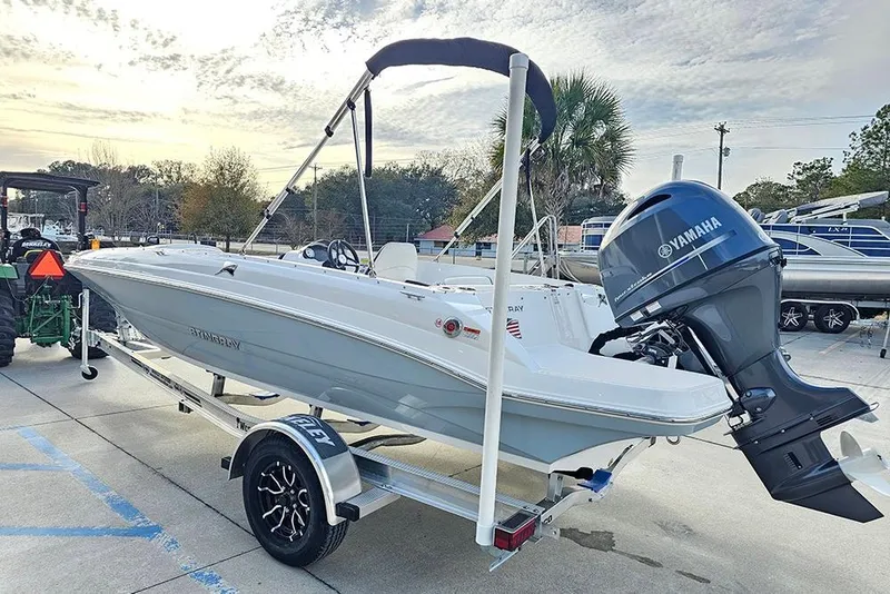 Slide: The Image of 2026 Stingray 182 SC boat on trailer with Yamaha outboard motor, parked outdoors. - 7
