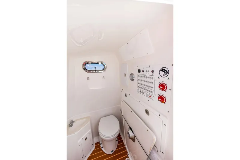 Slide: The Image of 2026 Edgewater 325CC boat interior with toilet and control panel. - 12