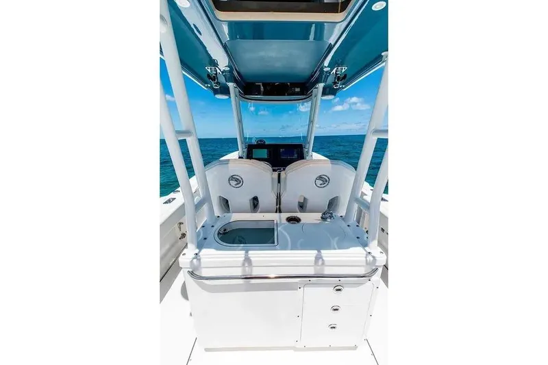 Slide: The Image of 2026 Edgewater 325CC boat interior with dual seats and ocean view. - 14