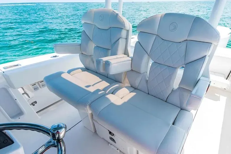 Slide: The Image of Luxury seating on 2026 Edgewater 325CC boat with ocean backdrop. - 15