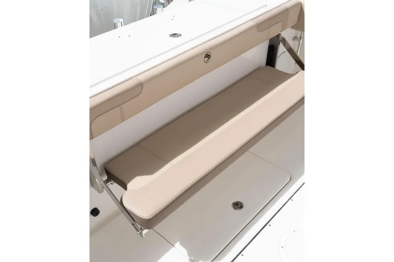 Slide: The Image of 2026 Edgewater 325CC boat with beige fold-down bench seat. - 16