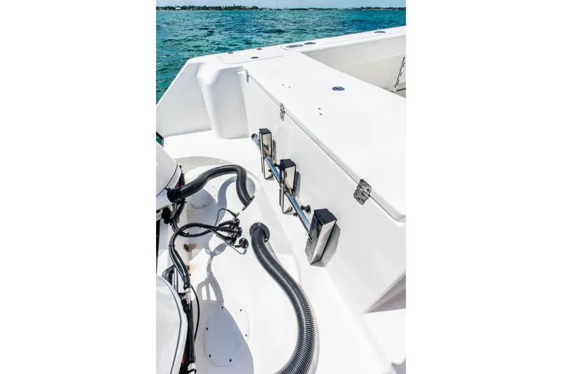 Slide: The Image of 2026 Edgewater 325CC boat deck with engine cables and ocean view. - 4