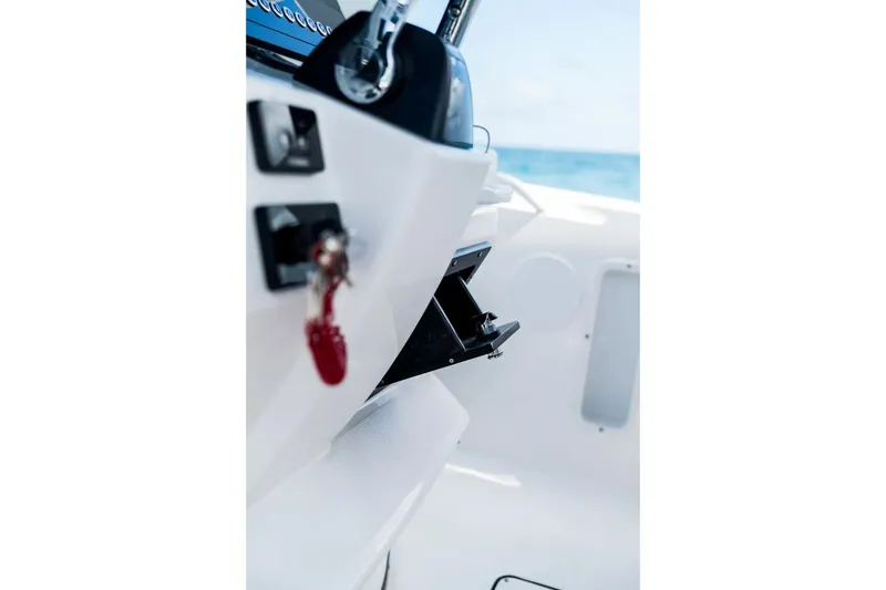 Slide: The Image of Edgewater 325CC 2026 boat interior with control panel and ocean view. - 5