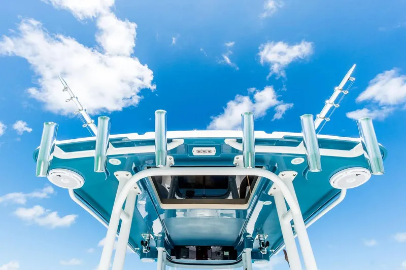 Slide: The Image of 2026 Edgewater 325CC boat roof against a bright blue sky with clouds. - 6
