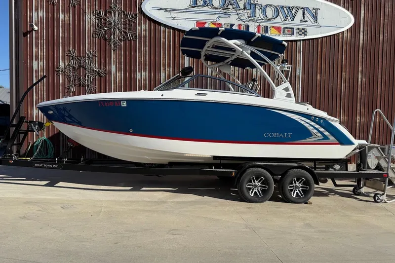 The Image of 2021 Cobalt R3 Surf boat on trailer at Boat Town, blue and white design. - 0