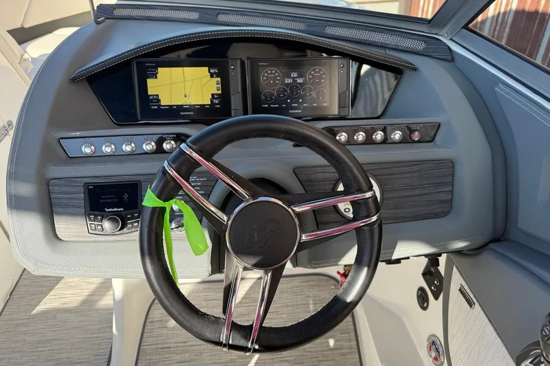 Slide: The Image of Steering wheel and dashboard of 2021 Cobalt R3 Surf boat with navigation display. - 10