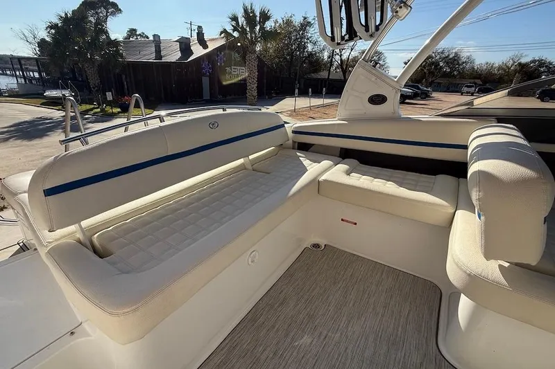 Slide: The Image of 2021 Cobalt R3 Surf boat interior with white cushioned seating and blue accents. - 18