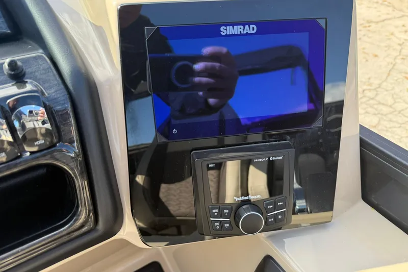 Slide: The Image of Control panel of 2026 Bentley Pontoons Elite 253 Admiral with Simrad display and audio system. - 15