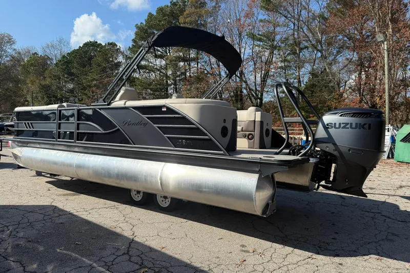 Slide: The Image of 2026 Bentley Pontoons Elite 253 Admiral with Suzuki engine, parked outdoors. - 4