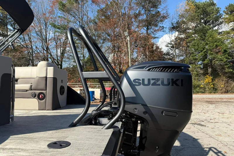 Slide: The Image of 2026 Bentley Pontoons Elite 253 Admiral with Suzuki outboard motor, outdoor setting. - 5