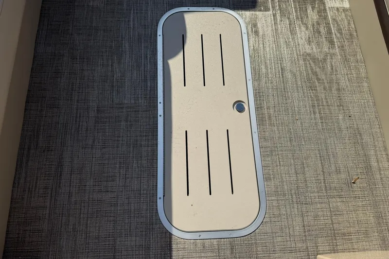 Slide: The Image of Floor hatch on 2026 Bentley Pontoons Elite 253 Admiral, featuring textured flooring. - 8