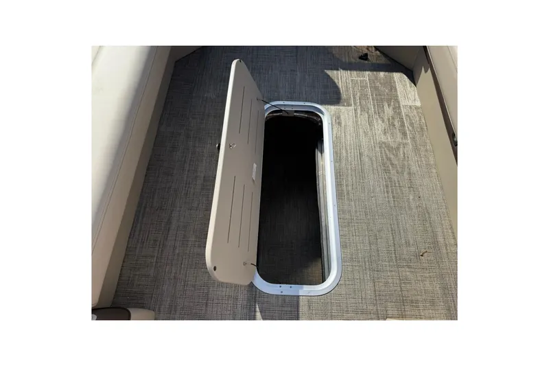 Slide: The Image of 2026 Bentley Pontoons Elite 253 Admiral storage compartment with open hatch on deck. - 9