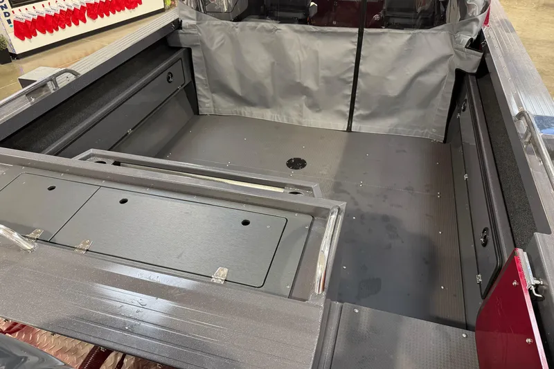 Slide: The Image of Interior of 2026 Duckworth 23 Pacific Navigator boat, featuring spacious deck and storage compartments. - 11