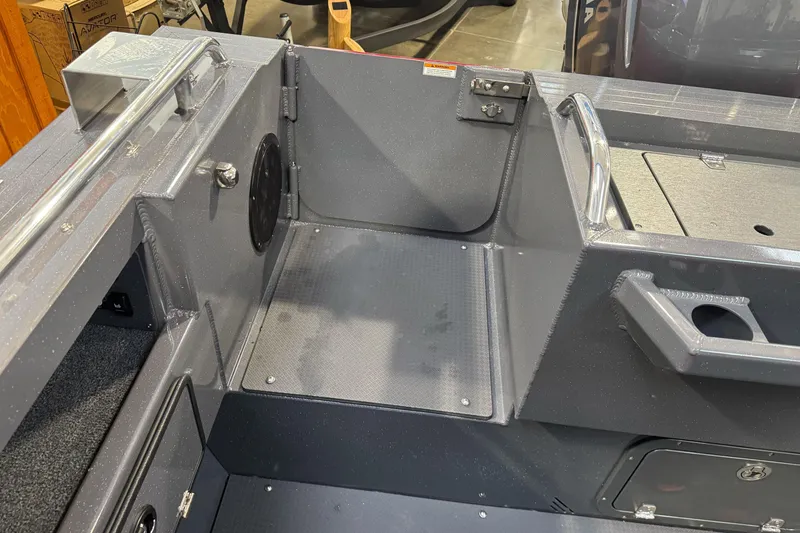 Slide: The Image of Interior view of 2026 Duckworth 23 Pacific Navigator boat, featuring seating and storage compartments. - 13