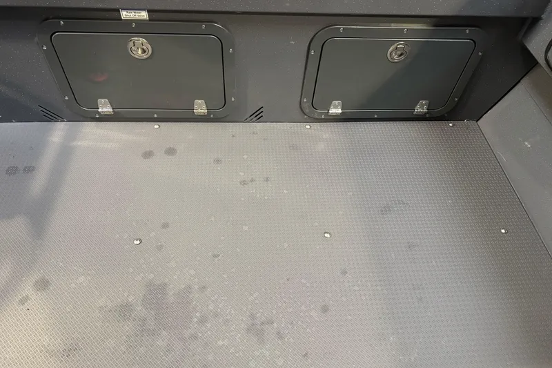 Slide: The Image of Interior view of 2026 Duckworth 23 Pacific Navigator boat with storage compartments. - 14