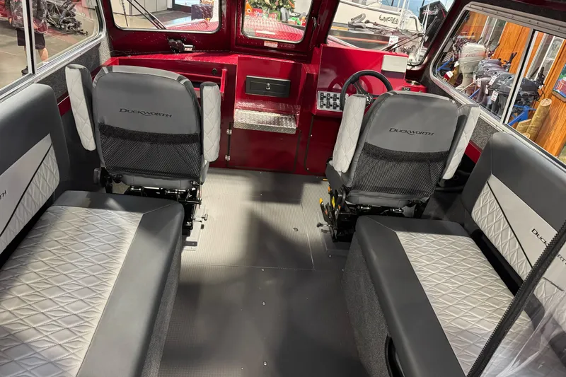 Slide: The Image of Interior of 2026 Duckworth 23 Pacific Navigator boat with modern seating and controls. - 18