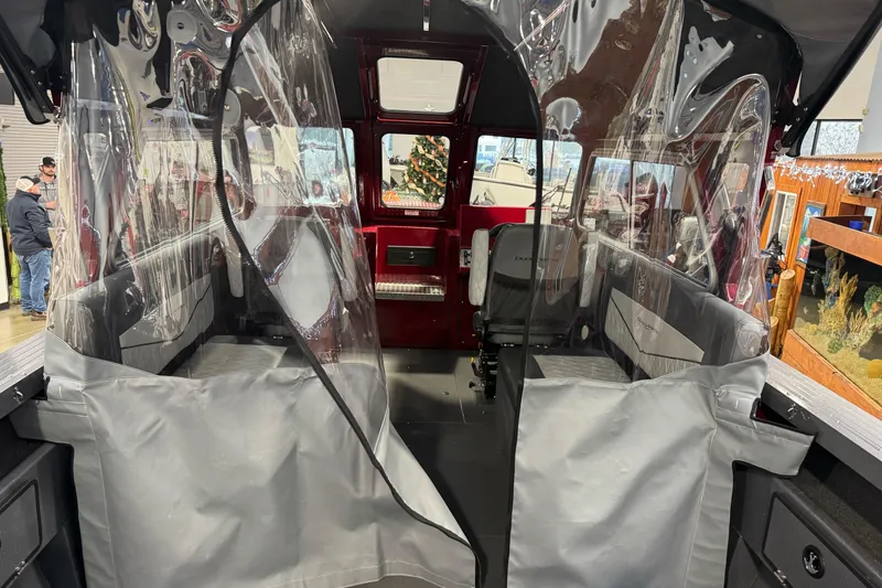 Slide: The Image of Interior view of 2026 Duckworth 23 Pacific Navigator boat with clear protective covers. - 19