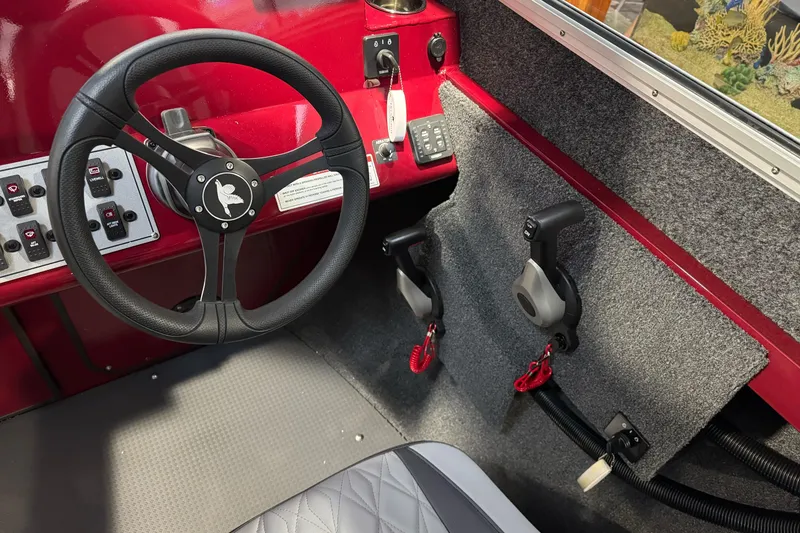 Slide: The Image of Interior of 2026 Duckworth 23 Pacific Navigator boat with steering wheel and controls. - 29