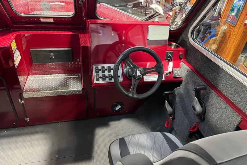 Slide: The Image of Interior of 2026 Duckworth 23 Pacific Navigator boat with red dashboard and steering wheel. - 30