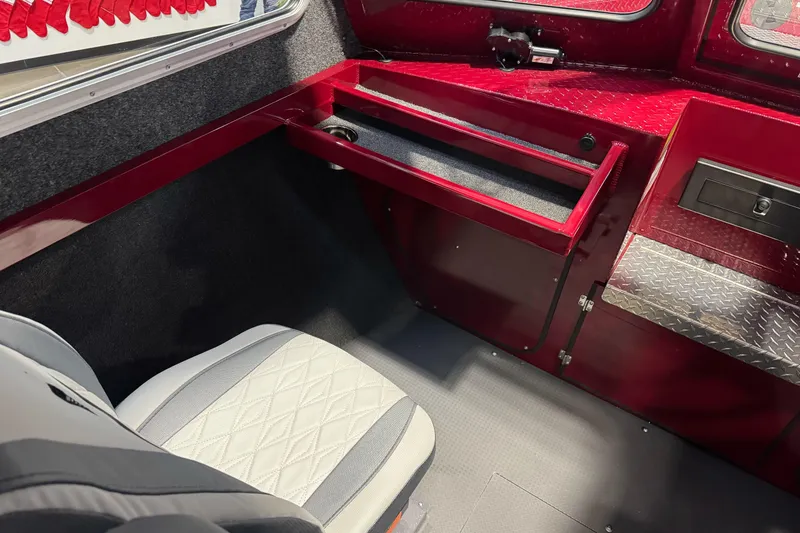 Slide: The Image of Interior of 2026 Duckworth 23 Pacific Navigator boat, featuring red and gray seating and storage. - 31
