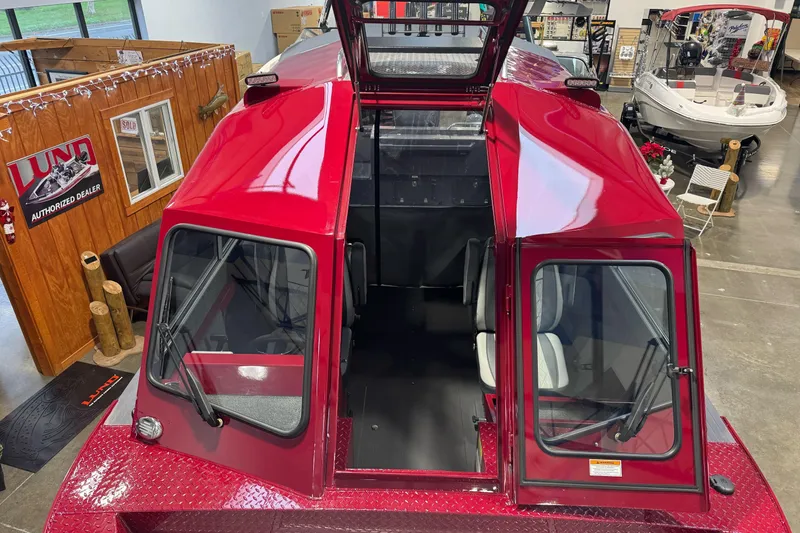 Slide: The Image of 2026 Duckworth 23 Pacific Navigator boat with red exterior in showroom. - 34