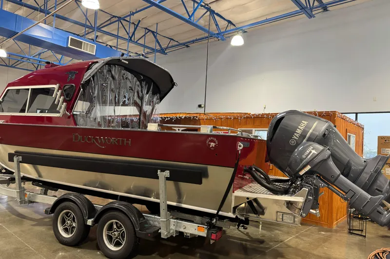 Slide: The Image of 2026 Duckworth 23 Pacific Navigator boat with Yamaha engine on trailer indoors. - 8