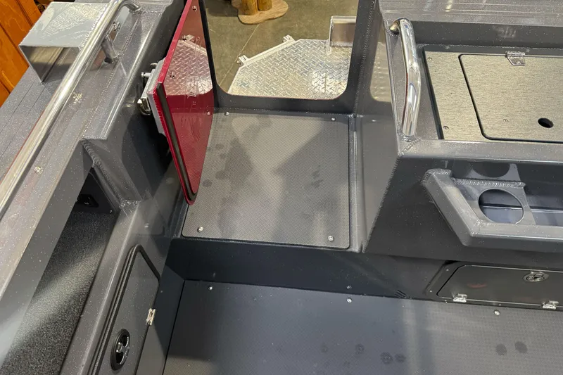 Slide: The Image of Interior view of 2026 Duckworth 23 Pacific Navigator boat, featuring storage compartments and seating. - 12