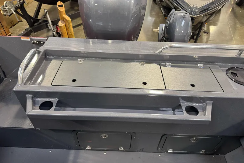 Slide: The Image of 2026 Duckworth 23 Pacific Navigator boat interior with storage compartments and cup holders. - 16