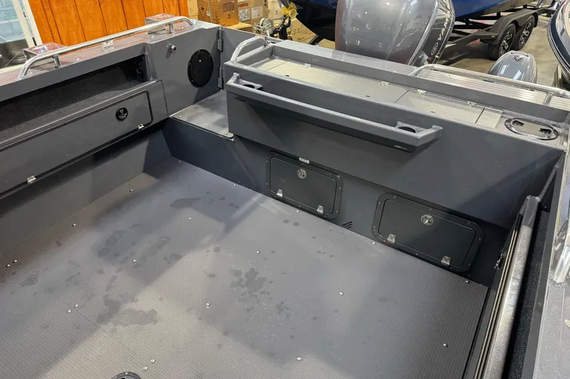 Slide: The Image of Interior of 2026 Duckworth 23 Pacific Navigator boat, showcasing storage compartments and seating. - 17