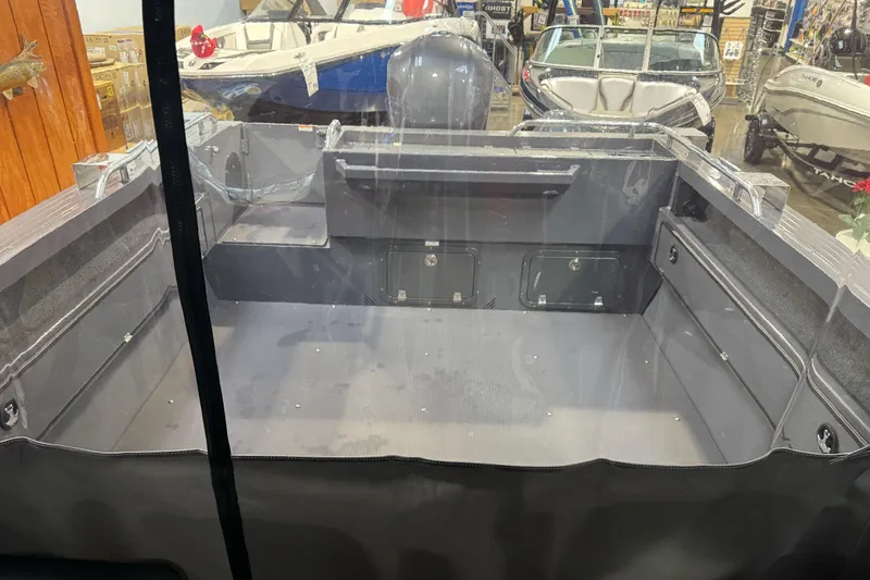 Slide: The Image of Interior view of a 2026 Duckworth 23 Pacific Navigator boat, showcasing spacious storage compartments. - 22