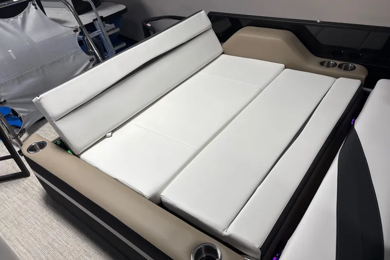 Slide: The Image of 2026 South Bay S224UL boat interior with white cushioned seating and cup holders. - 11