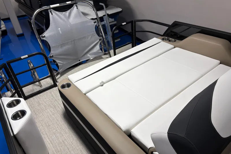 Slide: The Image of 2026 South Bay S224UL pontoon boat interior with white seating and cup holders. - 12