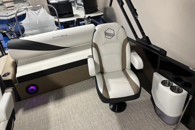 Slide: The Image of 2026 South Bay S224UL boat interior with plush seating and cup holders. - 6