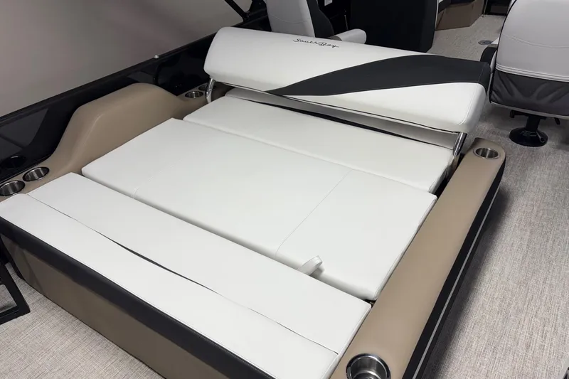 Slide: The Image of 2026 South Bay S224UL boat interior with white and beige seating, cup holders. - 9