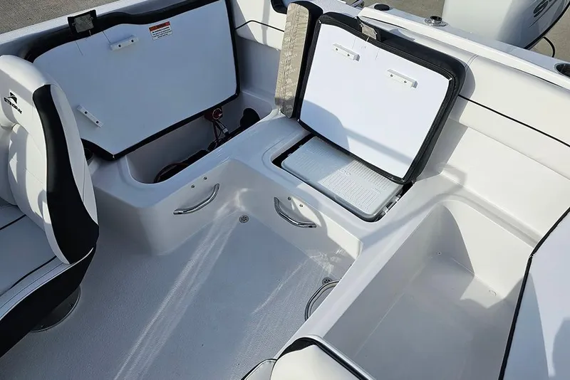 Slide: The Image of 2026 Stingray 172 DC boat interior with open storage compartments and seating. - 13