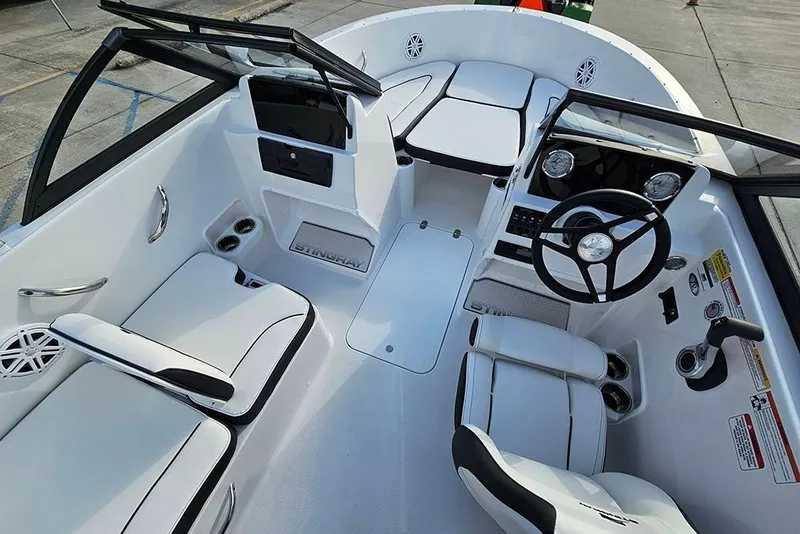 Slide: The Image of 2026 Stingray 172 DC boat interior with sleek white seating and modern dashboard. - 14