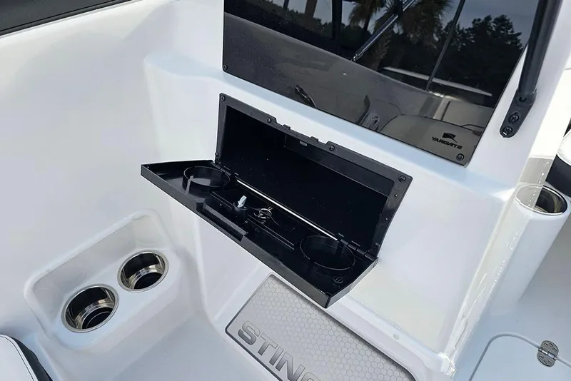 Slide: The Image of 2026 Stingray 172 DC boat interior with cup holders and storage compartment. - 15