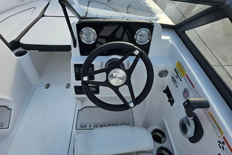 Slide: The Image of 2026 Stingray 172 DC boat cockpit with steering wheel and dashboard controls. - 17