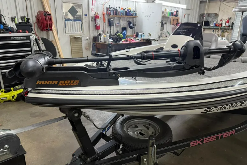 Slide: The Image of 2007 Skeeter SX180 boat with Minn Kota Maxxum trolling motor in a workshop setting. - 2