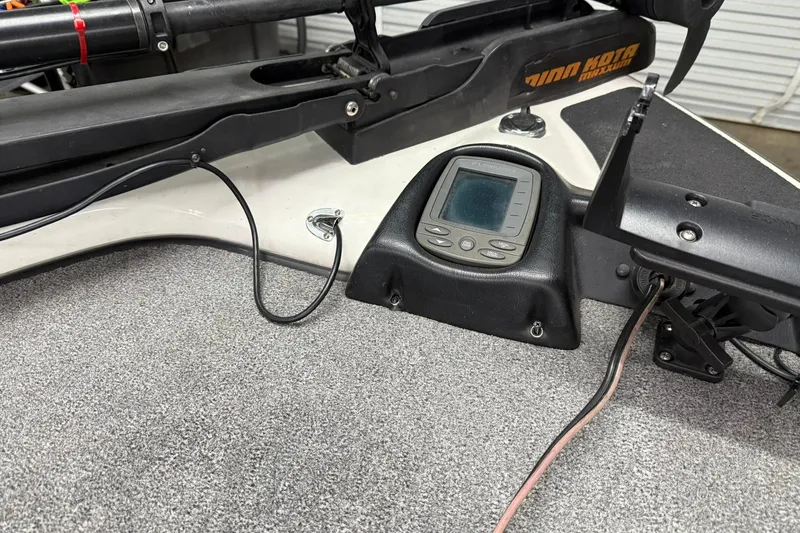 Slide: The Image of 2007 Skeeter SX180 boat dashboard with fish finder and trolling motor controls. - 3