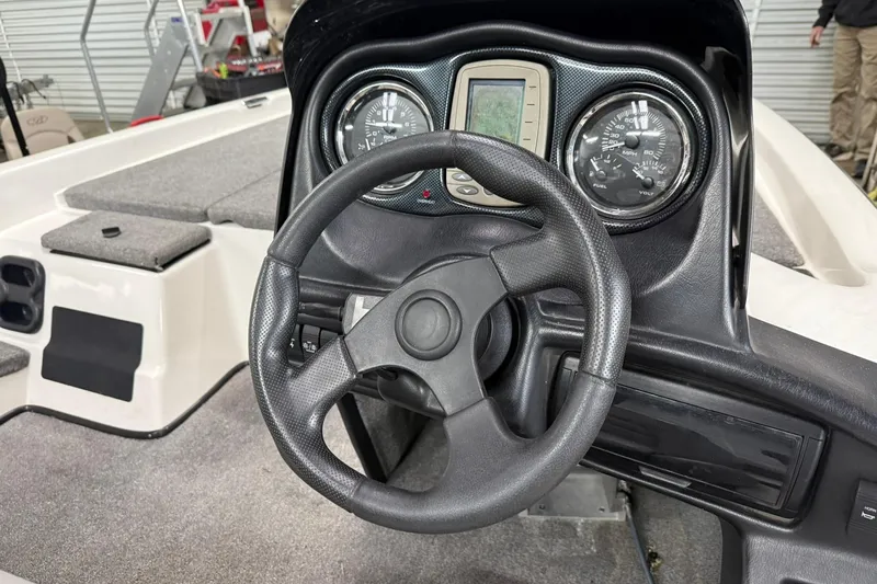 Slide: The Image of 2007 Skeeter SX180 boat dashboard with steering wheel and gauges. - 5