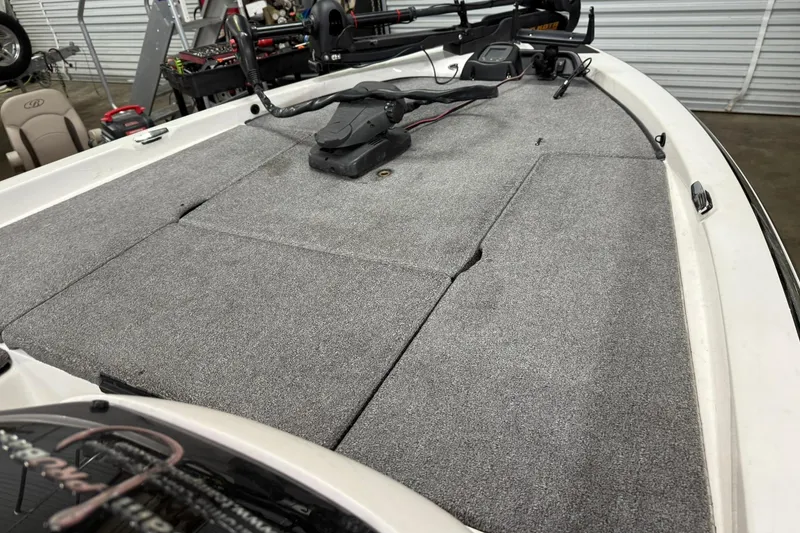 Slide: The Image of 2007 Skeeter SX180 boat deck with carpeted surface and fishing equipment. - 6