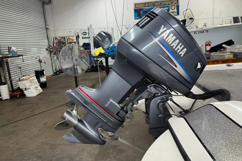 Slide: The Image of 2007 Skeeter SX180 with Yamaha outboard motor in a workshop setting. - 7